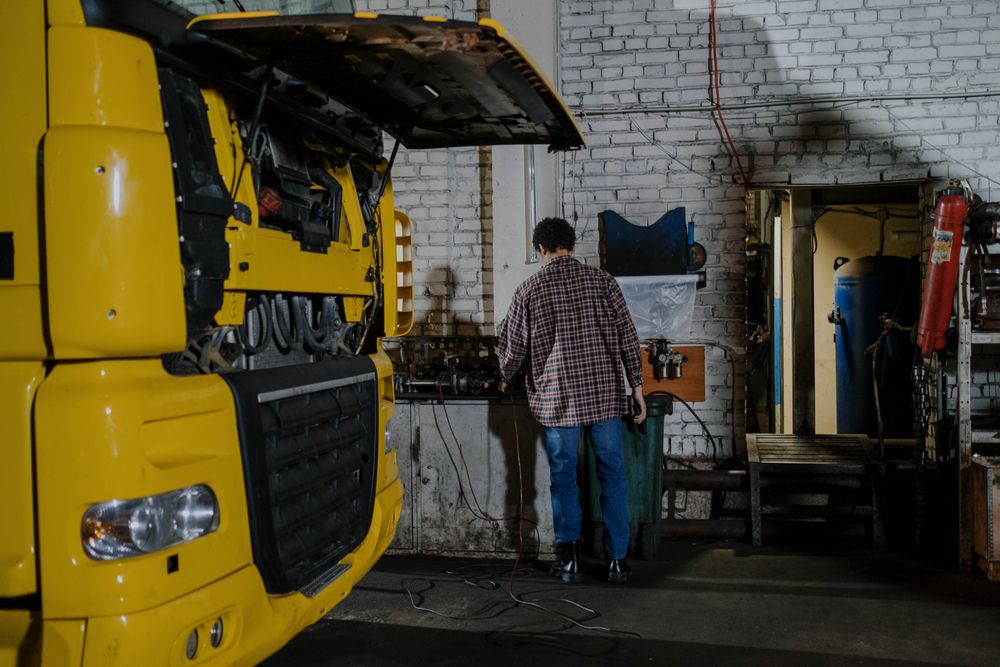 Mechanic performing engine diagnostics on a truck
