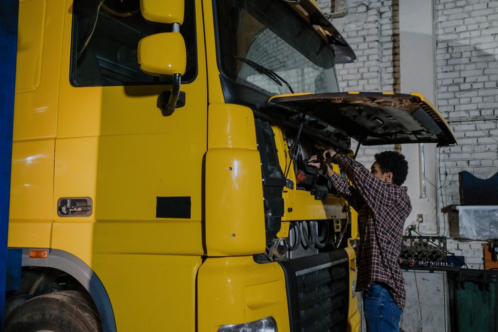 Technician repairing a truck in the workshop