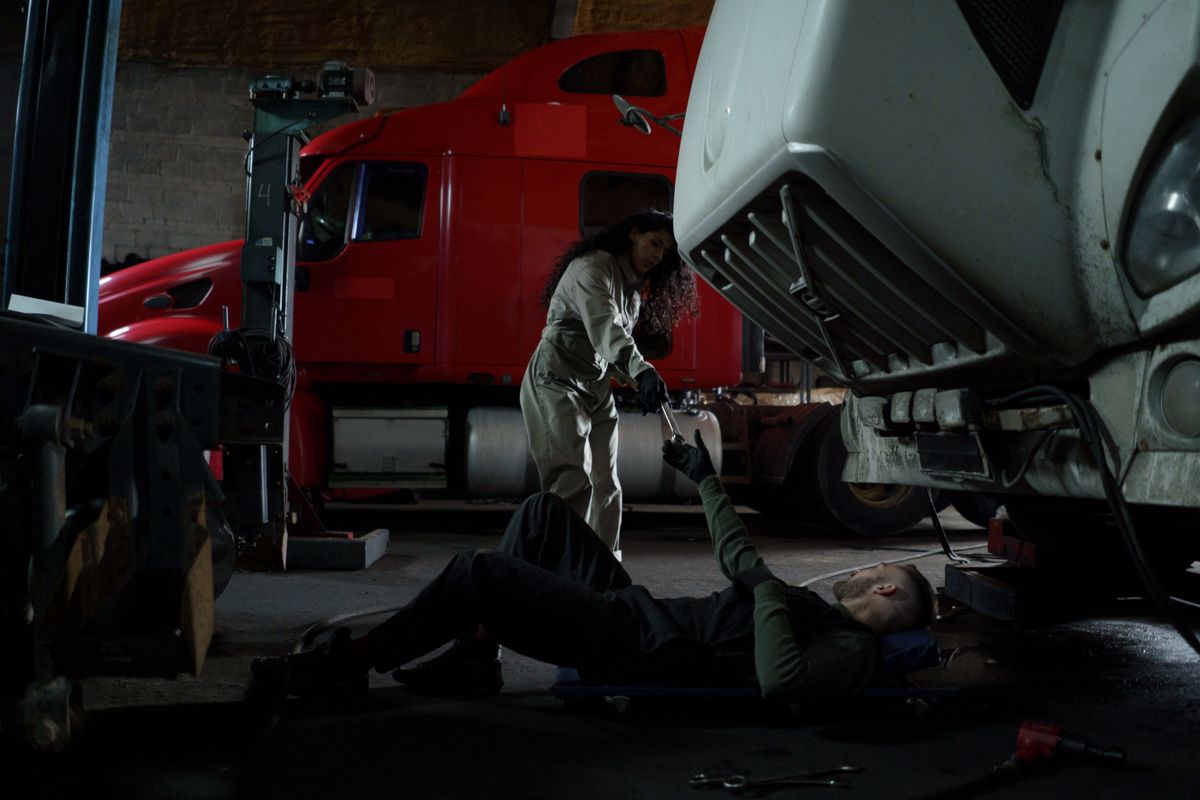 Two A.S Garage diesel technicians repairing a truck together